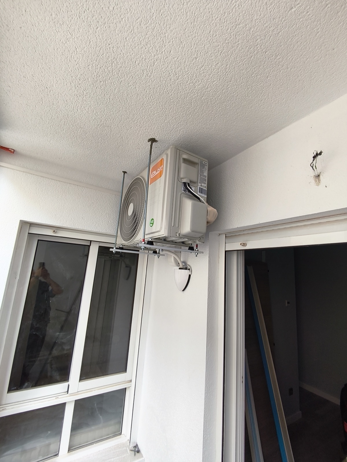 AC outdoor unit on bracket on balcony