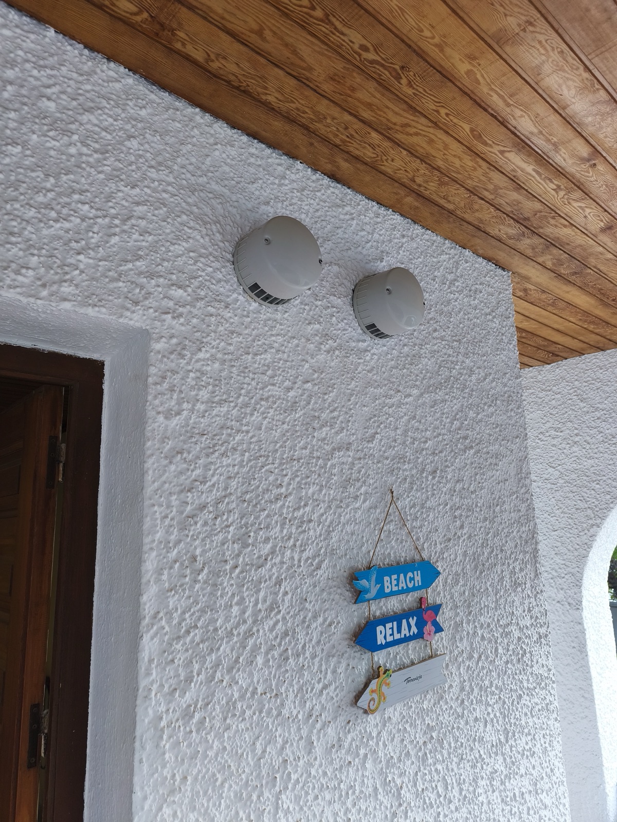 Two ventilation grilles on outer white wall