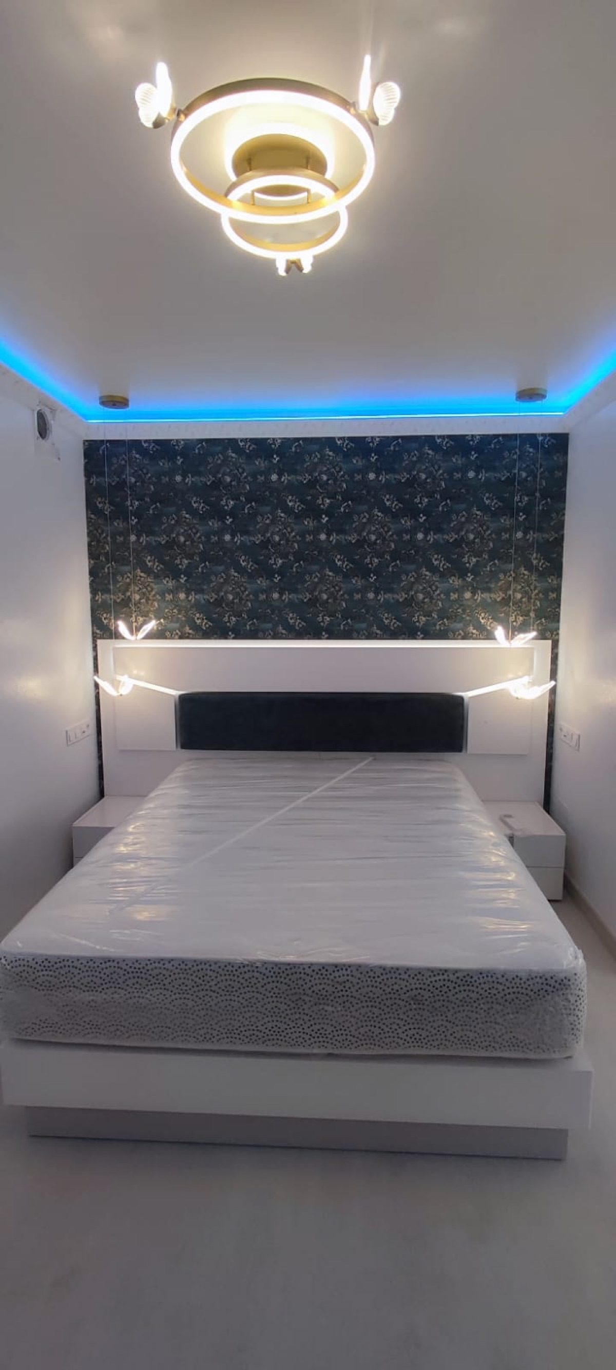 Bedroom with LED lighting and designer chandelier
