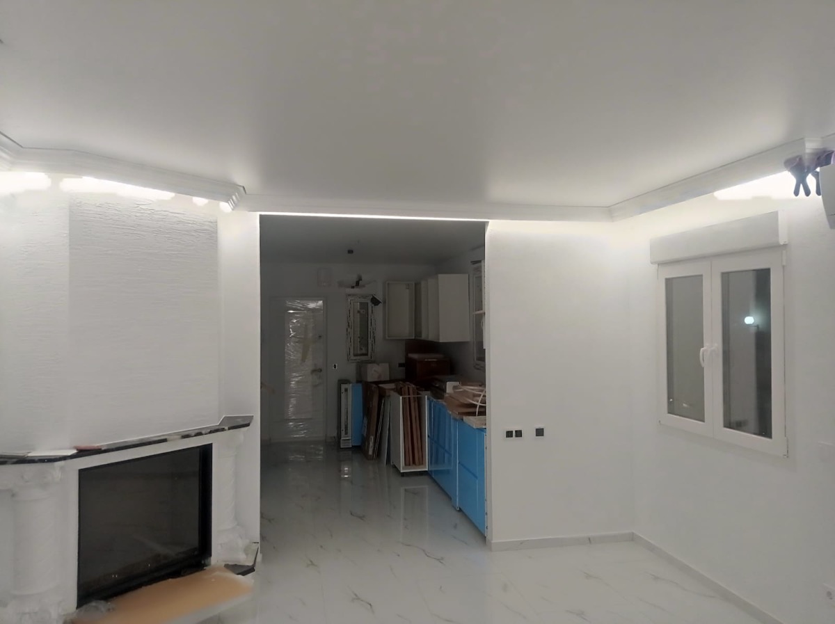 Ceiling LED lighting in living room with fireplace