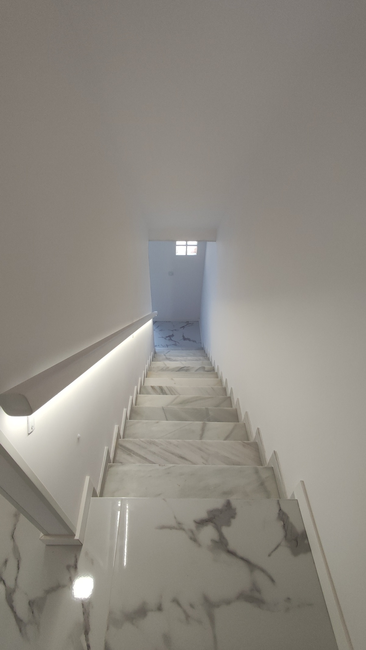 Staircase with LED handrail lighting