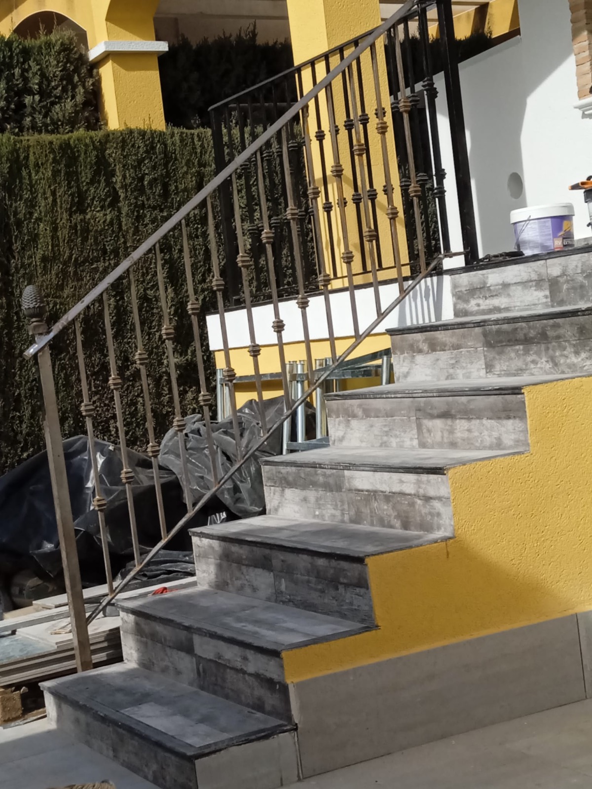 Outdoor staircase with wrought iron railings